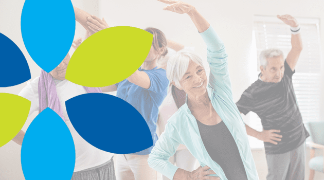 A group of older adults participate in a standing group exercise class, stretching with arms raised; abstract blue and green flower graphic overlays the image.