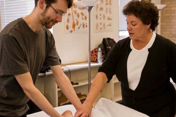 Student and instructor during a hands-on training. NWHSU massage therapy degree