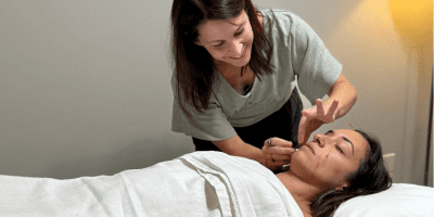 Dr. Heidi Kimmer, a practitioner at the Bloomington Clinic providing a facial acupuncture treatment